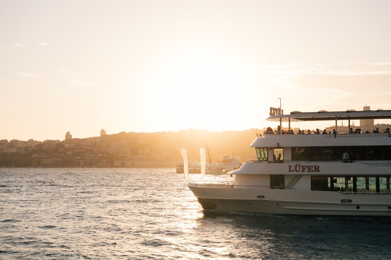 Passenger ship crossing a harbor at sunset, when genuinely cheap sailings can appear
